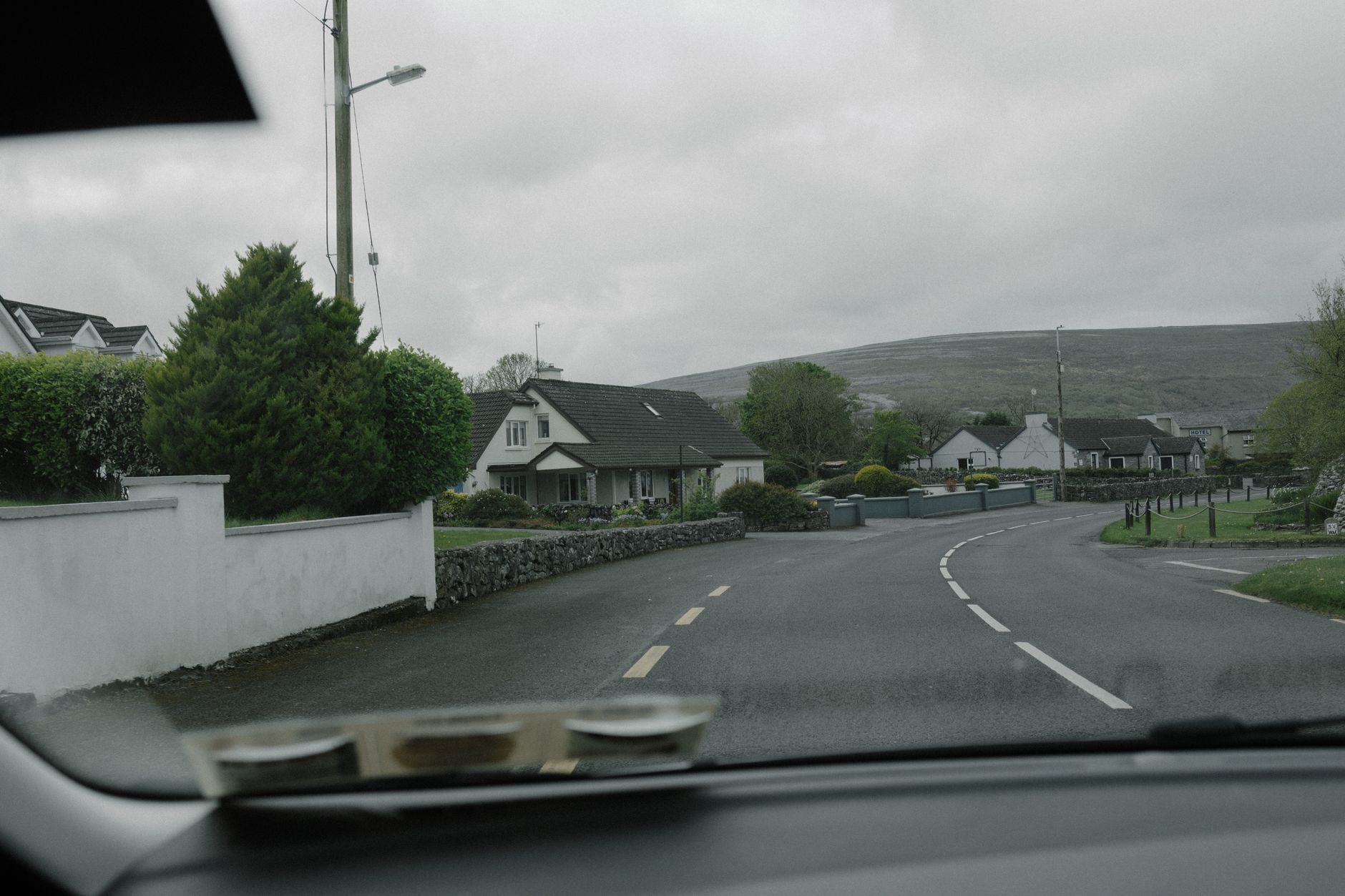 A quiet suburban residential street, the kind of road a beginner takes their first lessons on